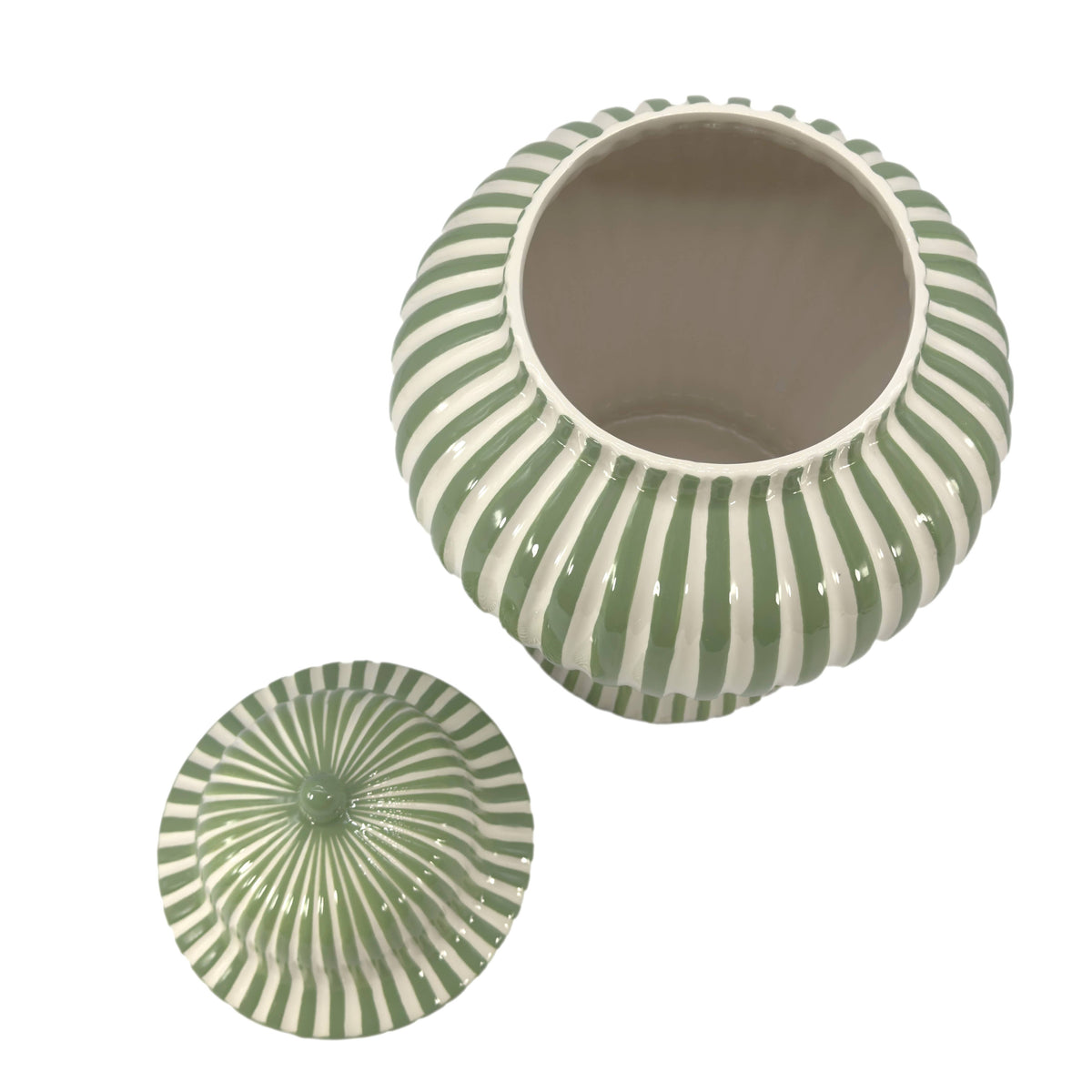 Tall green and white striped ceramic vase used as a statement accent in a seasonal home display.