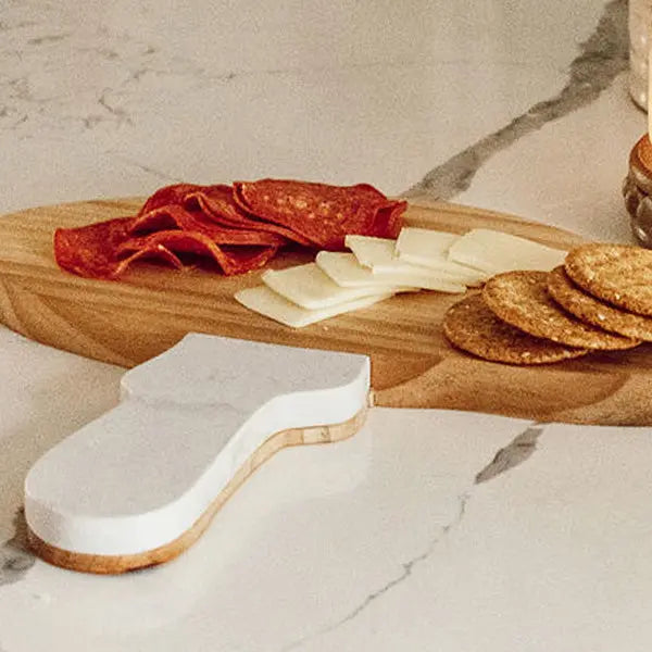 Marble and Wood Mushroom Cutting Board—mushroom-shaped board with white marble top and wooden base.