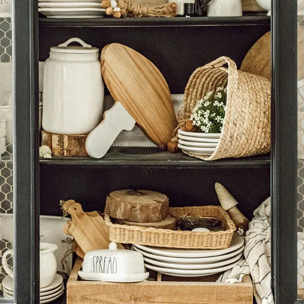 Marble and Wood Mushroom Cutting Board displayed on a shelf among dishes.