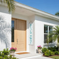Vertical Beach Home reversible vinyl banner on a white porch, teal BEACH HOME sign, two-sided designs.