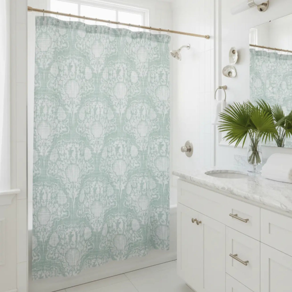 Coastal Crest Shower Curtain in seafoam damask adds vintage coastal calm to a white bathroom.