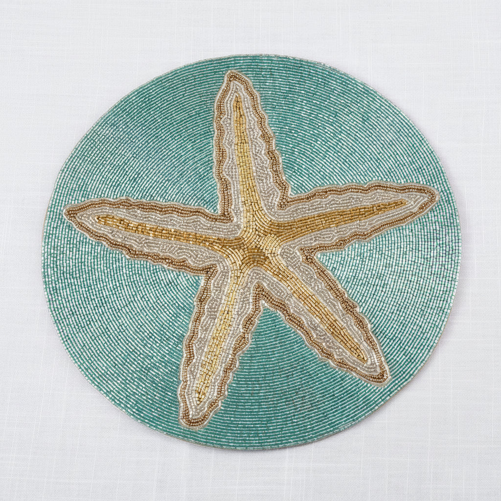 Round beaded starfish placemat in turquoise and neutral shades adding a glam coastal touch to the table.
