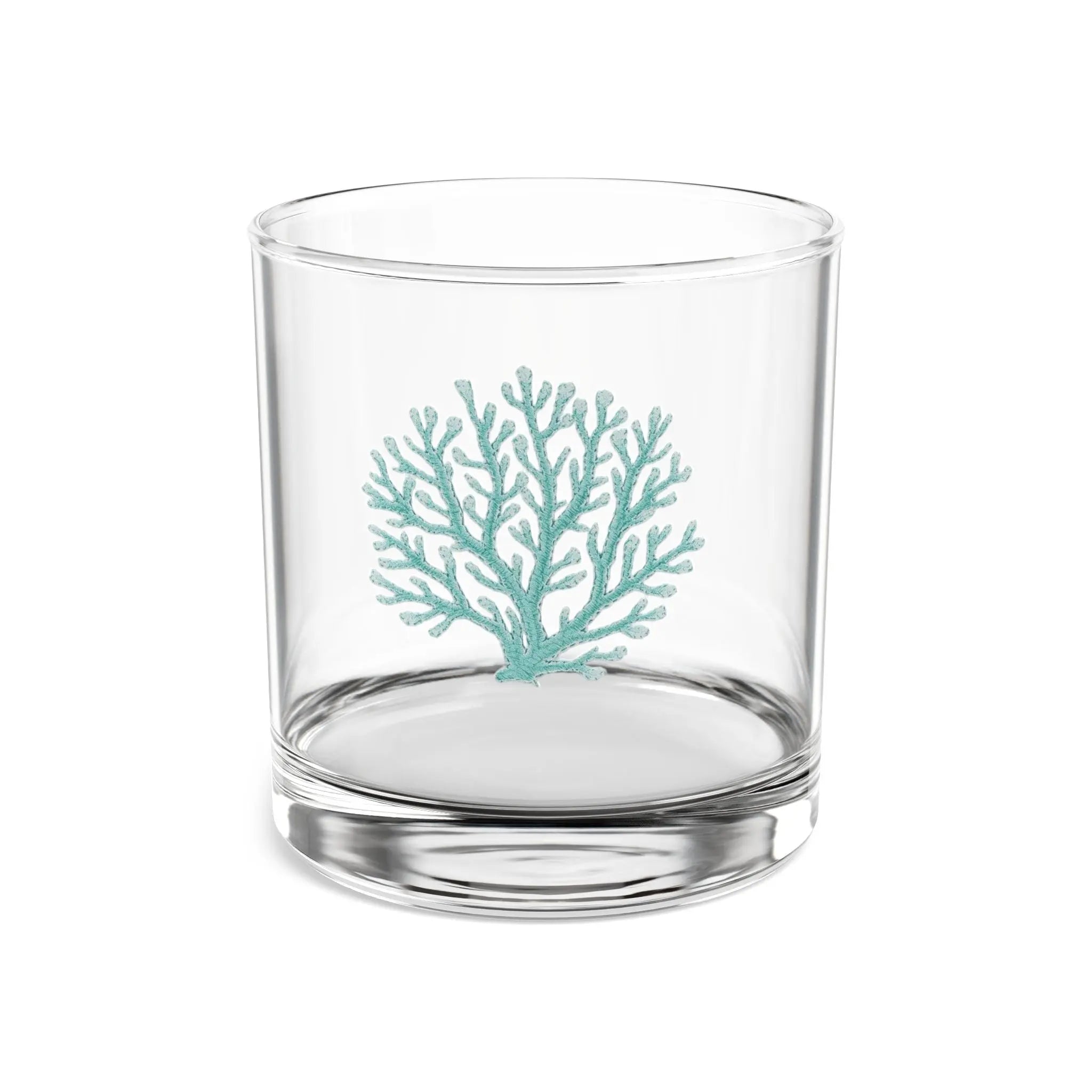 Rim and base detail of teal coral cocktail glass with coastal design.
