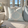 Aqua damask accent pillow adding a touch of color to a coastal home.