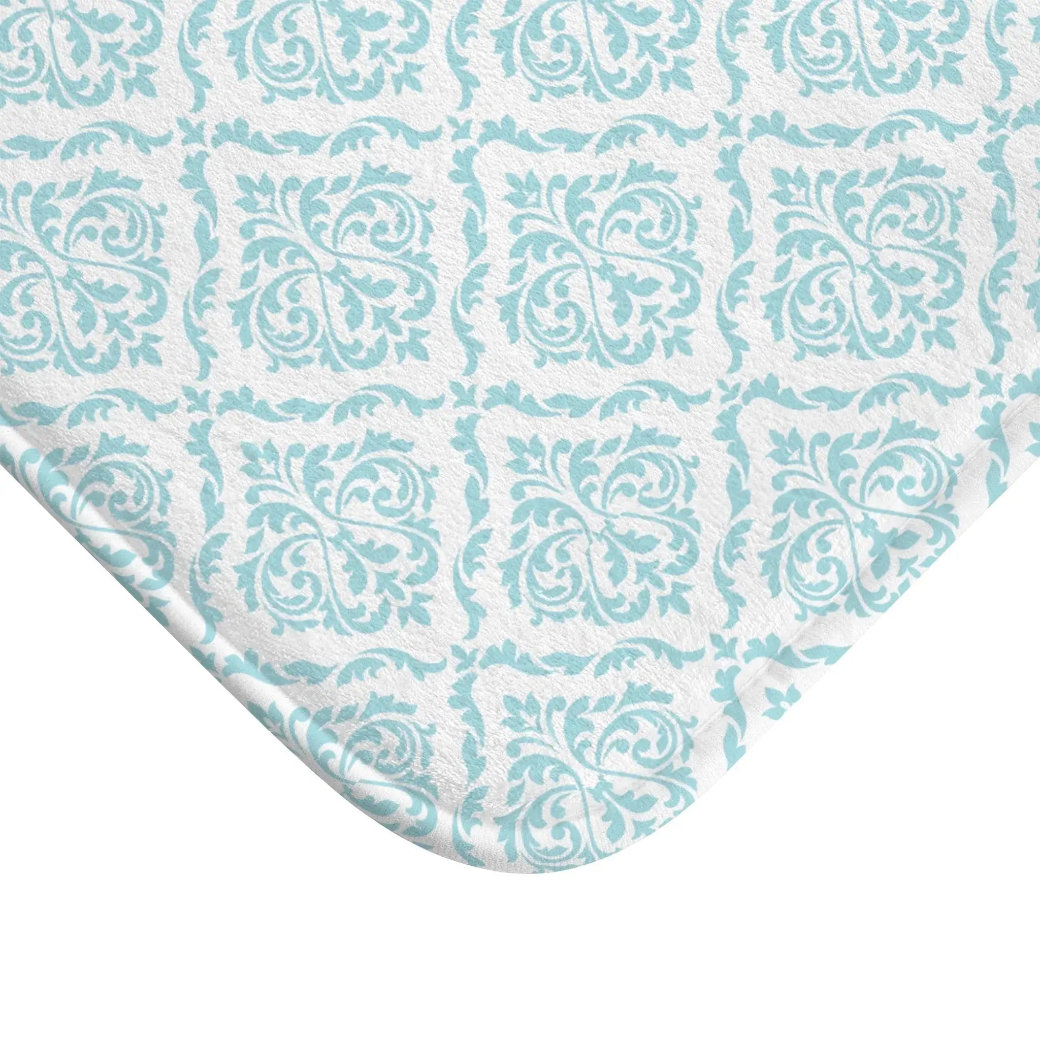 Texture detail of aqua damask bath mat showing soft, absorbent pile