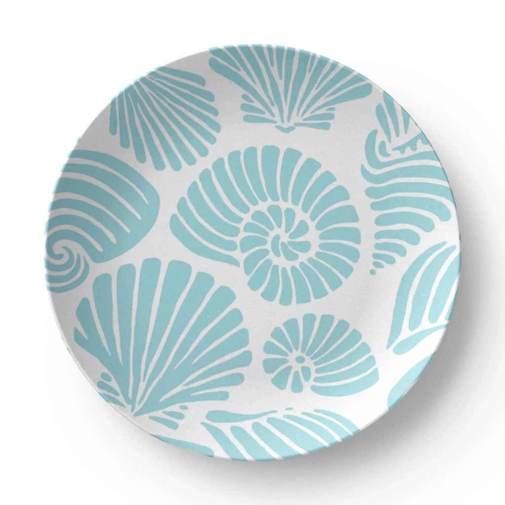 Closeup of aqua seashell motif on coastal dinner plate