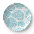 Closeup of aqua seashell motif on coastal dinner plate