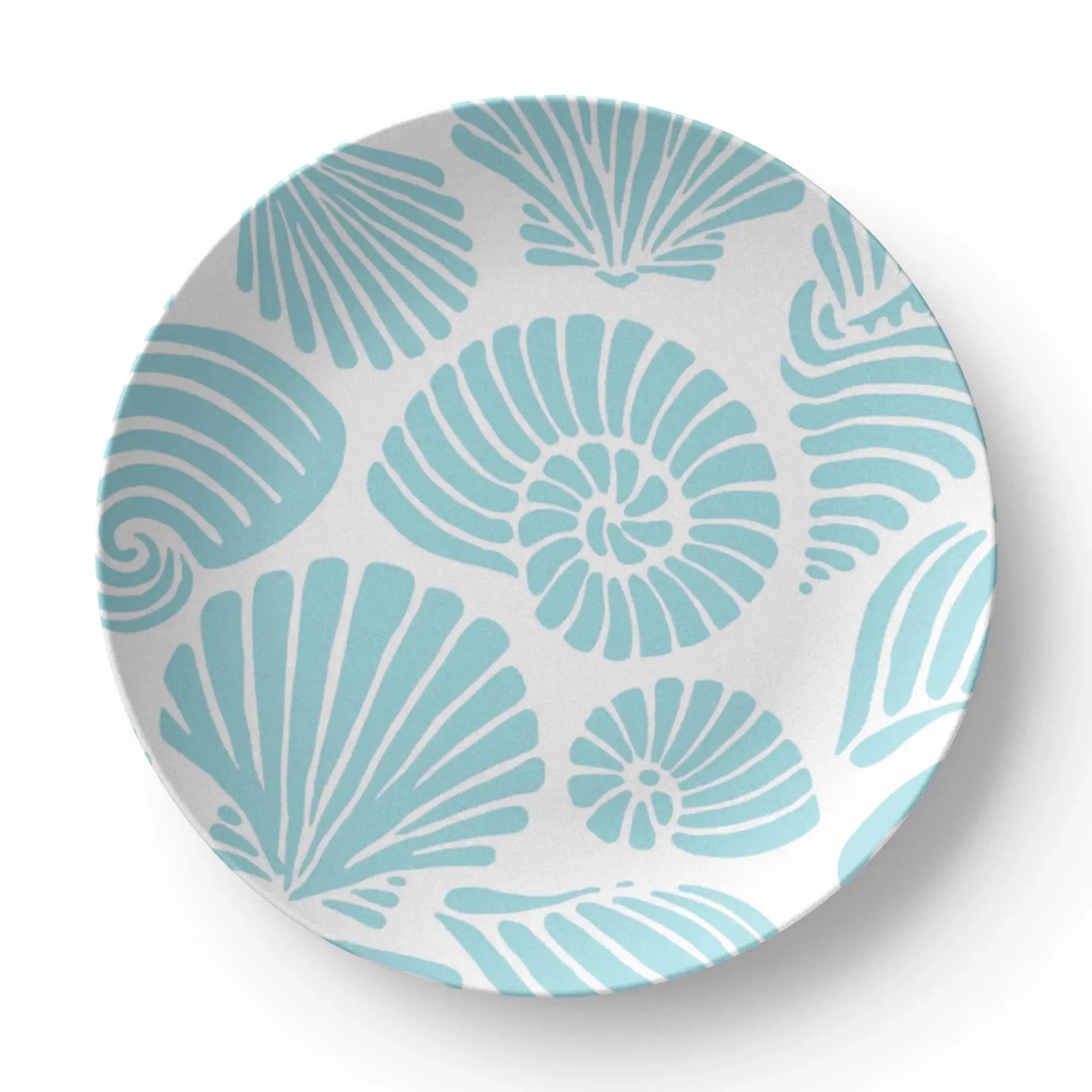 Closeup of aqua seashell motif on coastal dinner plate
