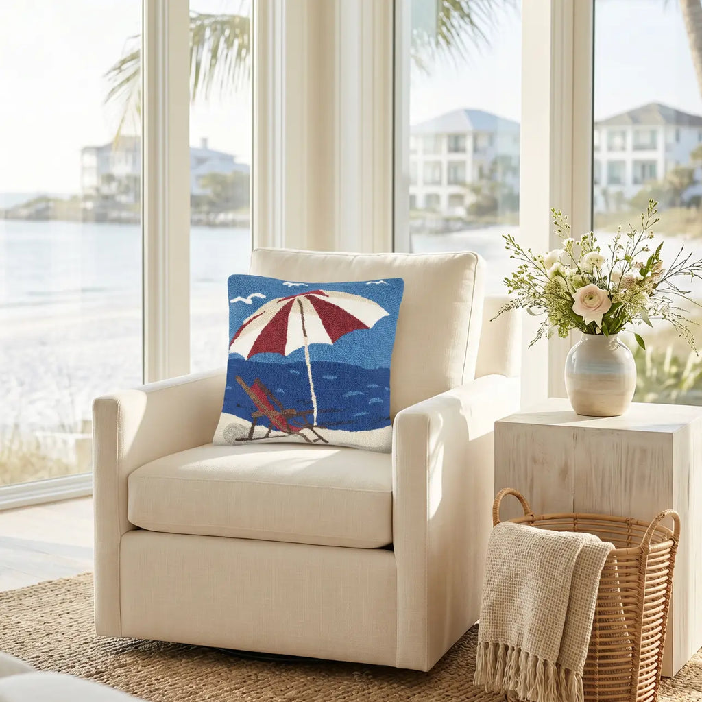 Beach chair coastal throw pillow on a white sofa in a beach house living room