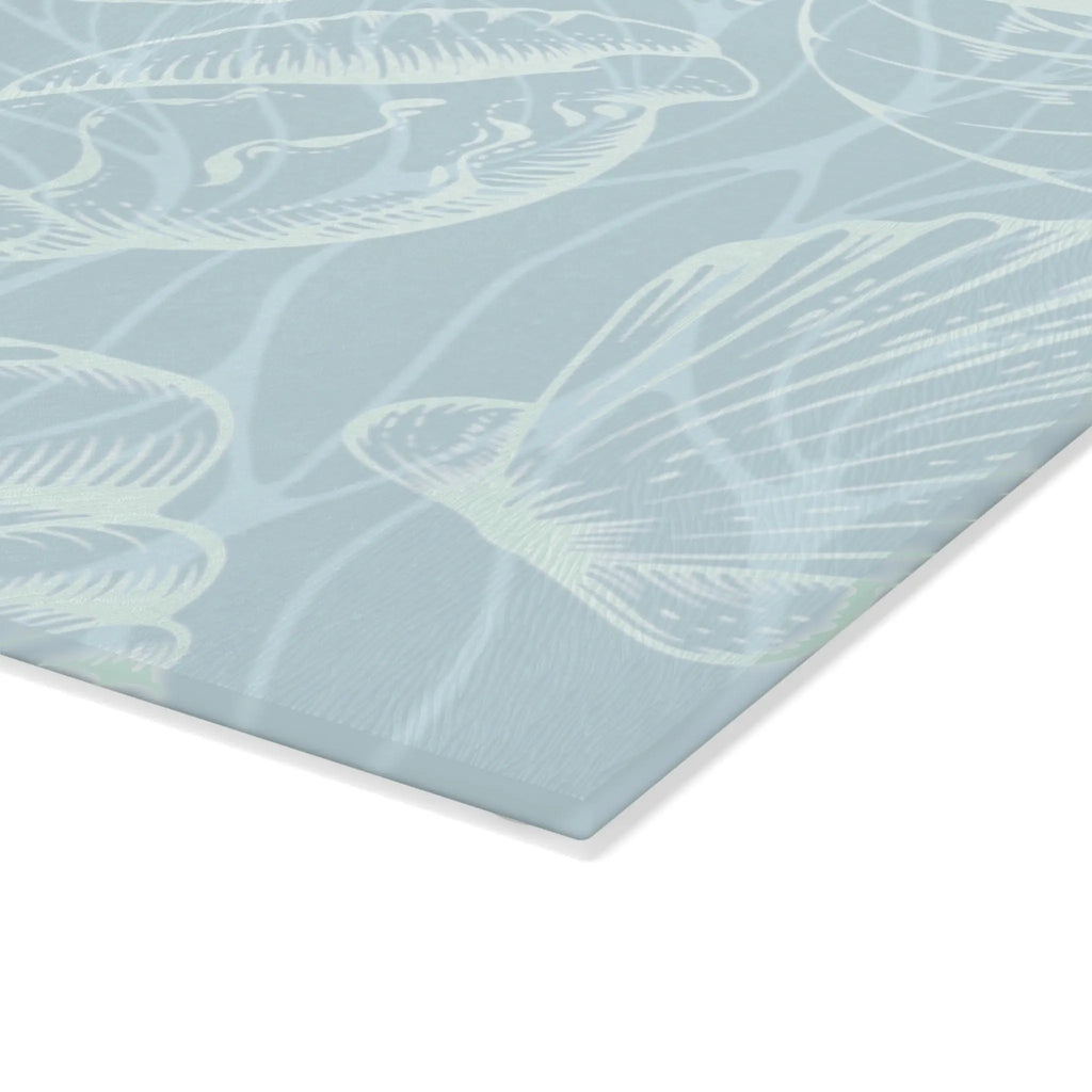 Coastal seashell glass cutting board in seafoam, featuring a seashell pattern on tempered glass.