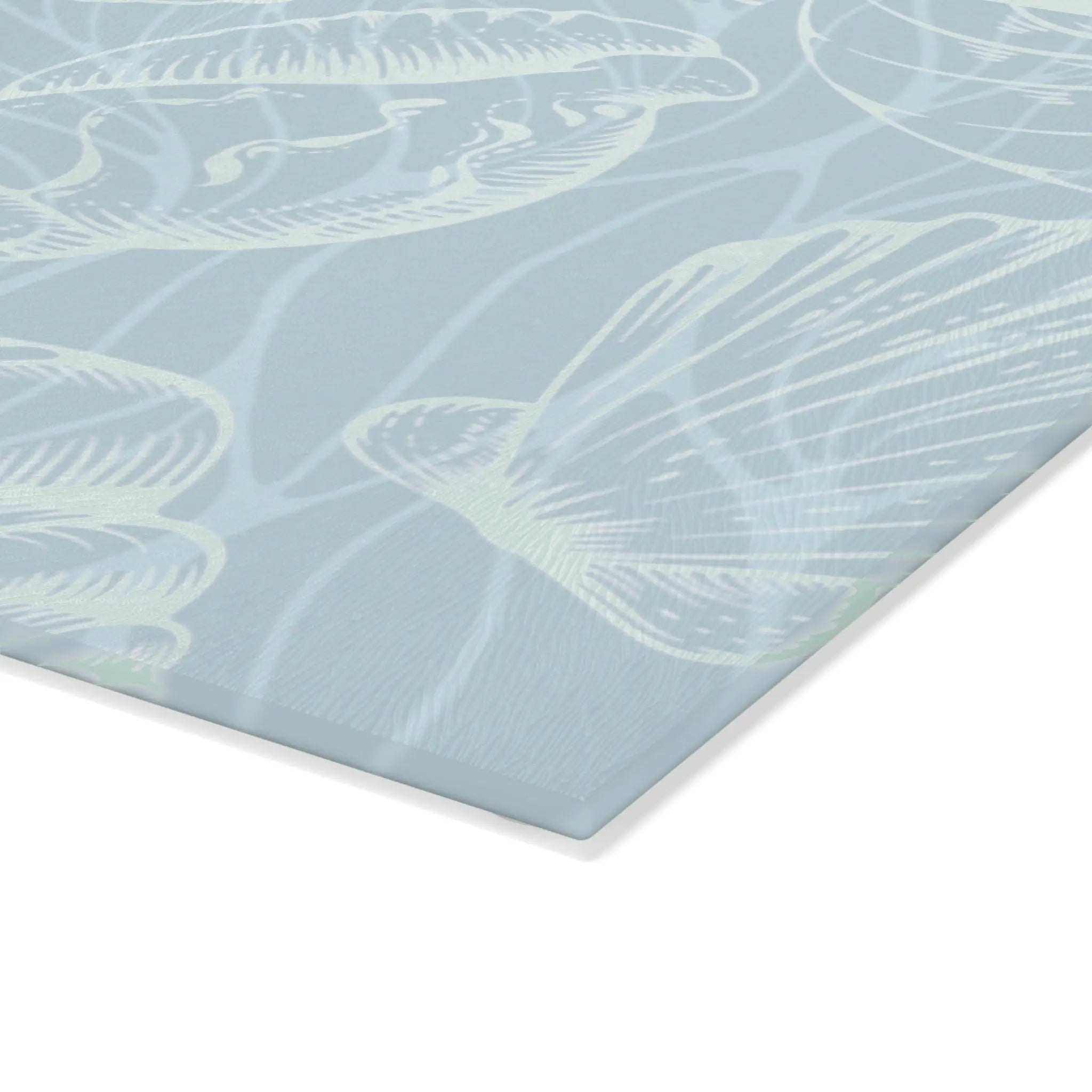 Coastal seashell glass cutting board in seafoam, featuring a seashell pattern on tempered glass.