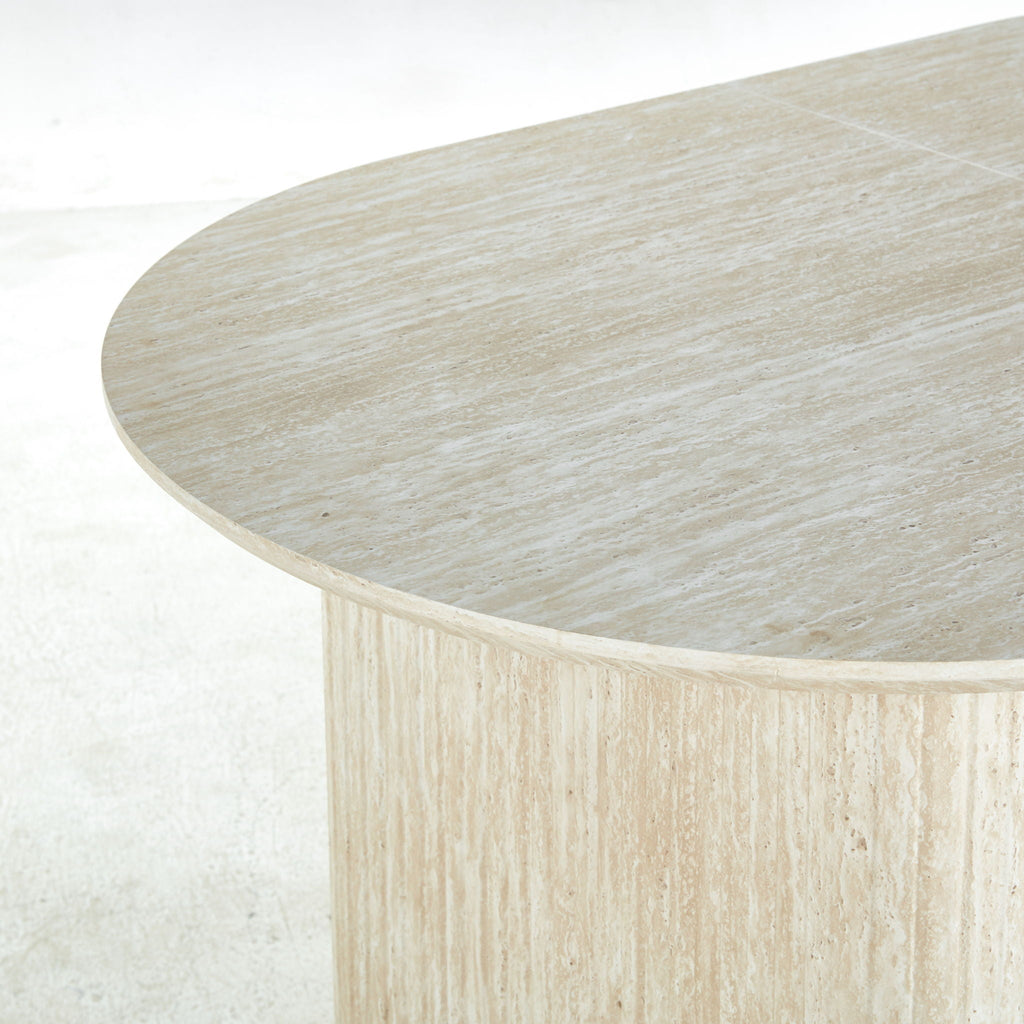 Beach house oval pedestal dining table with natural wood texture and contemporary fluted bases