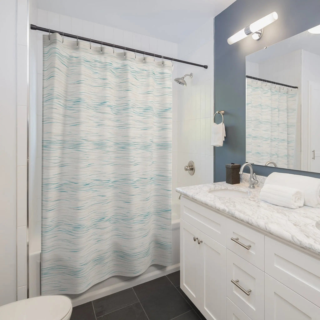 Coastal Breeze Shower Curtain, 100% polyester with pale blue watercolor waves, in a white bathroom.