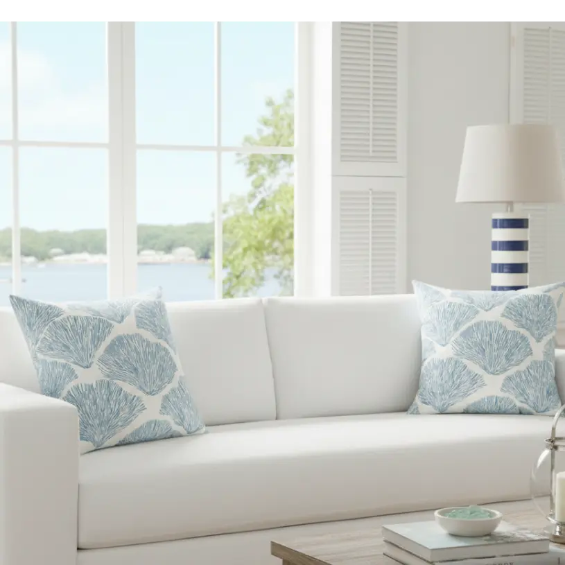 Bar Harbor Coral Throw Pillow in Coastal Blue Shell Pattern on white sofa