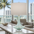 Decorative teal coastal lamp on a side table 