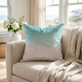 Beach ombre throw pillow on a couch in a coastal living room