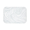 Coastal abstract bath mat for a  beach-inspired bathroom.
