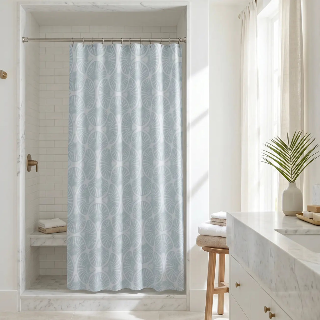 Beach house bathroom featuring a soft blue shell pattern curtain