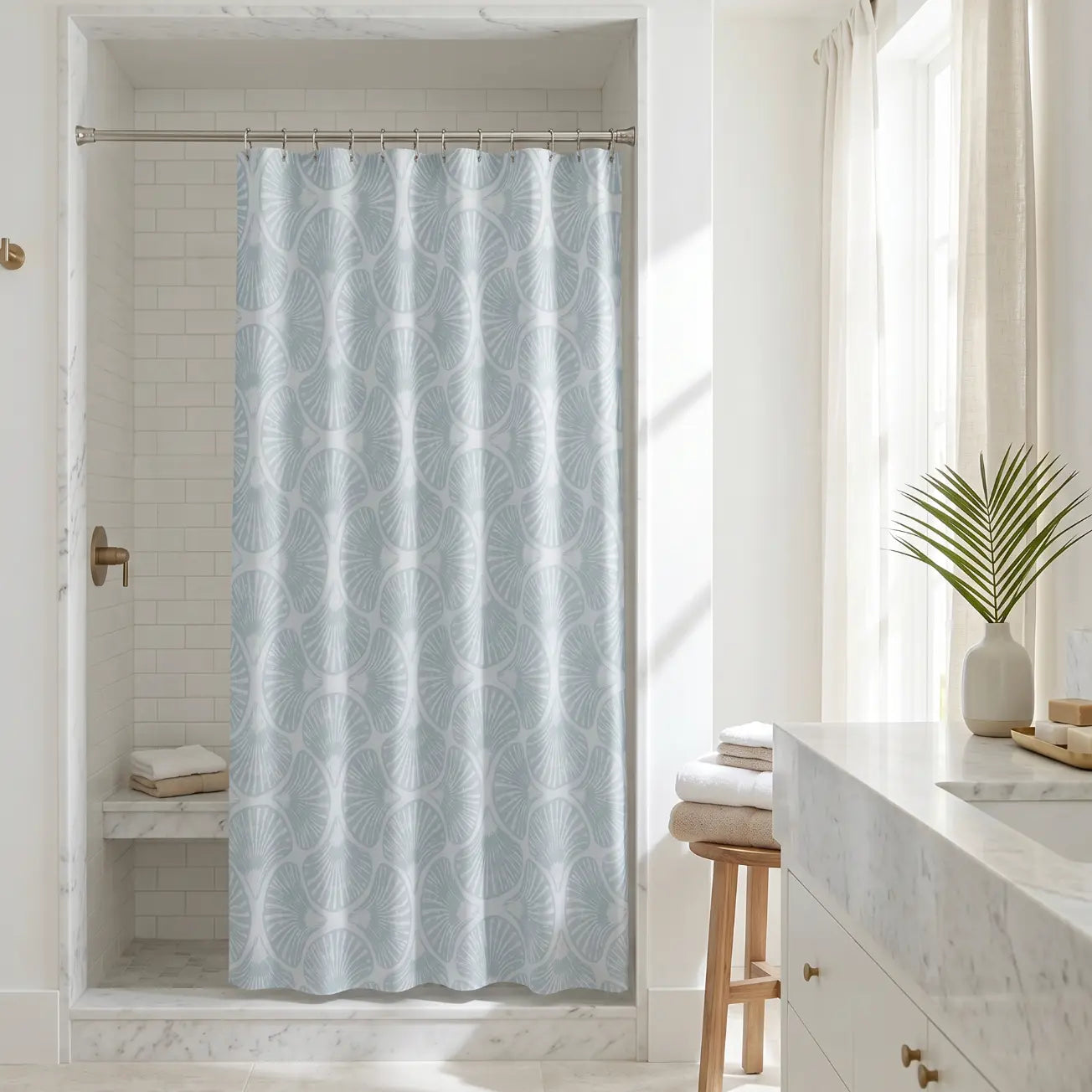 Beach house bathroom featuring a soft blue shell pattern curtain