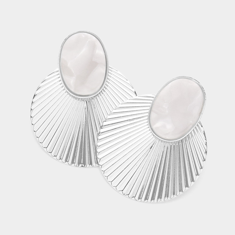Coastal oval marble resin and metal shell drop earrings shown as beach inspired statement jewelry