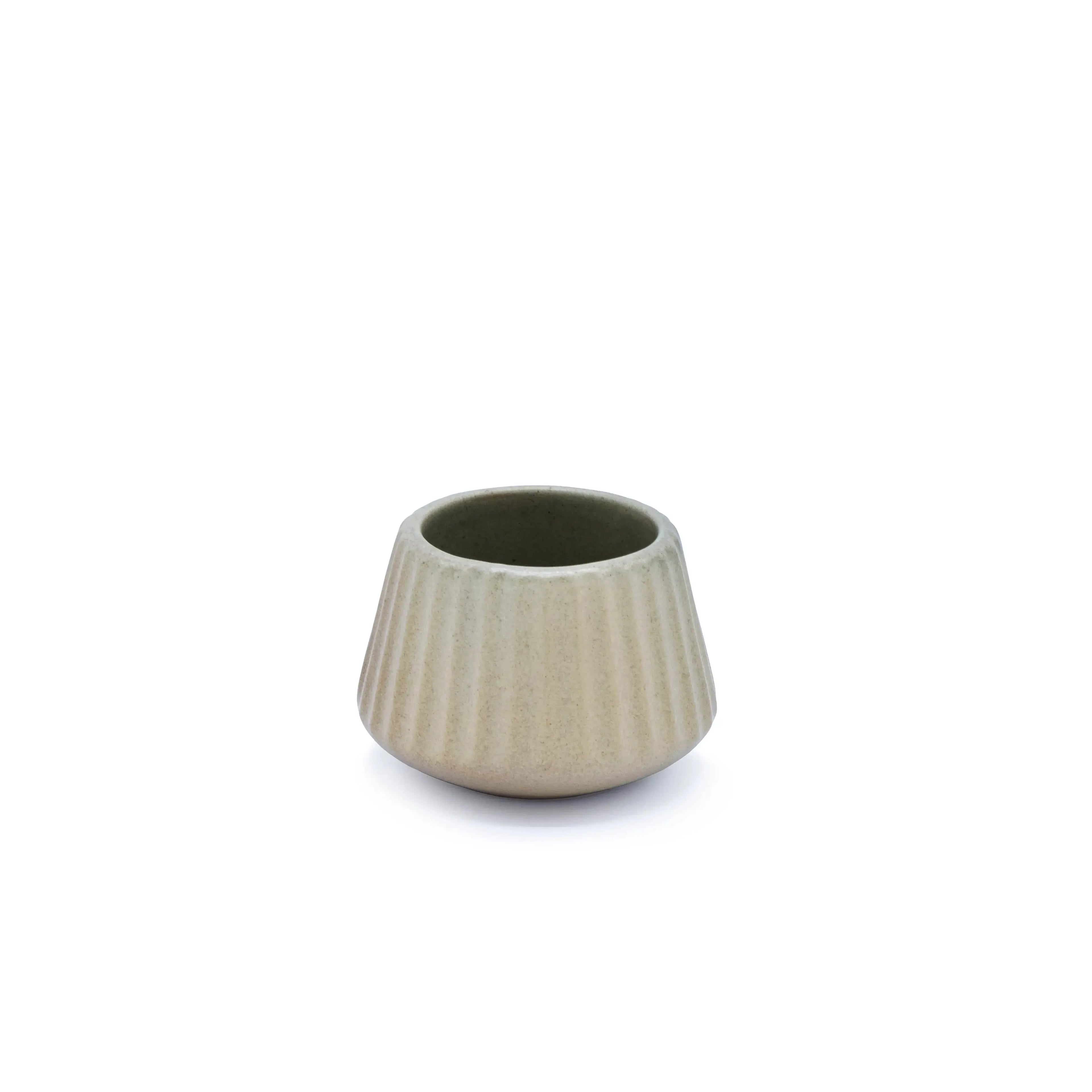 beige cocktail glass on an outdoor table in a beach-inspired patio setting.
