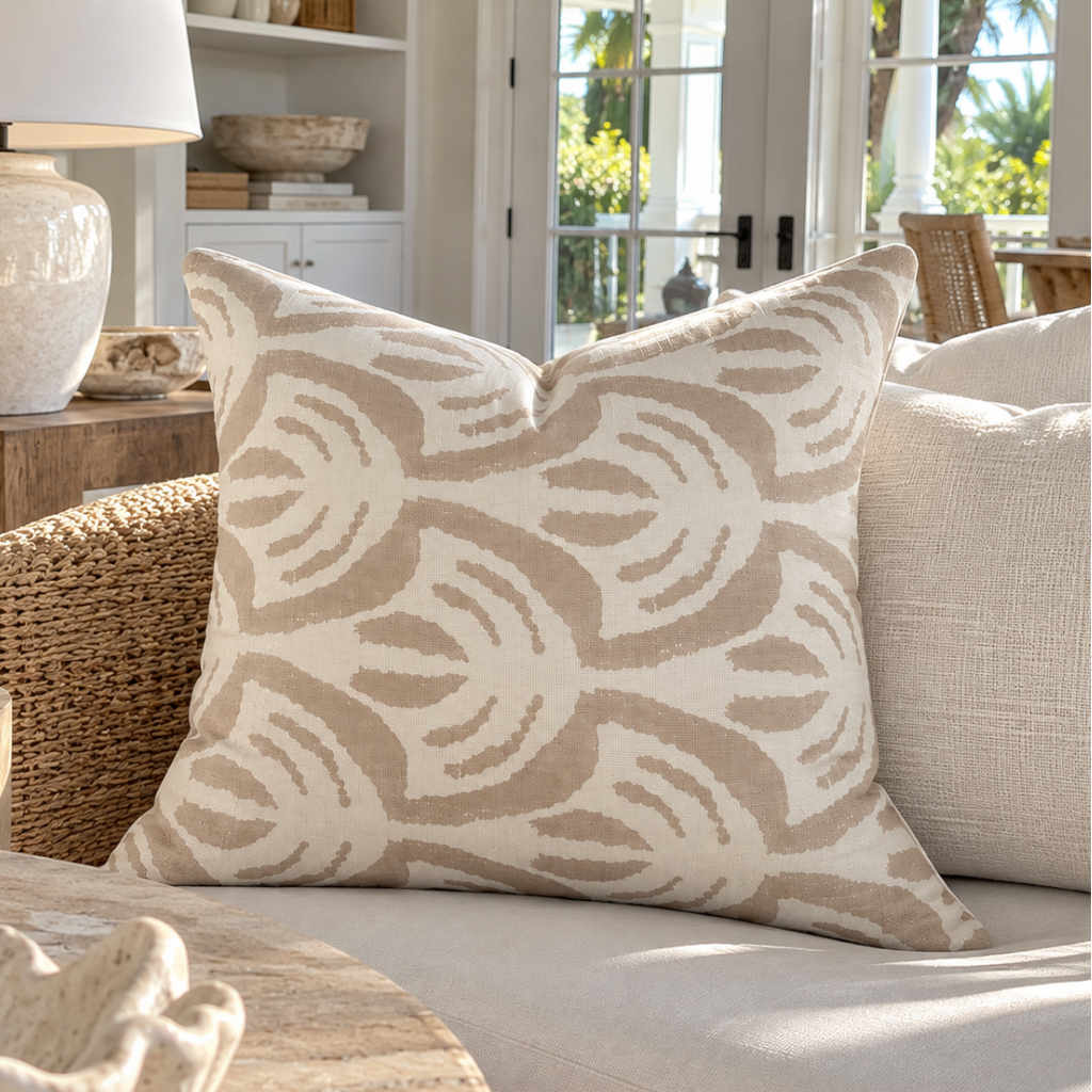 Beige and ivory decorative throw pillow styled in a luxury coastal home.