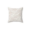 Beige leaf-pattern throw pillow with white leaf outlines on a sand-toned background.