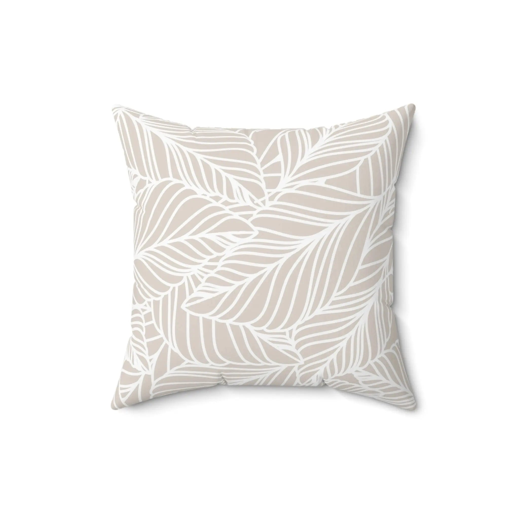 Beige leaf-pattern throw pillow with white foliage on sand background, coastal and Scandinavian decor.
