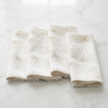 Beige palm motif linen napkins, set of four, styled with coastal place settings for casual entertaining.