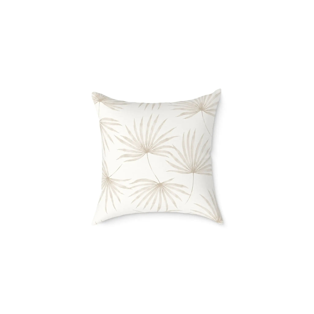 Neutral beige palm leaf pillow adding tropical texture to a coastal sofa