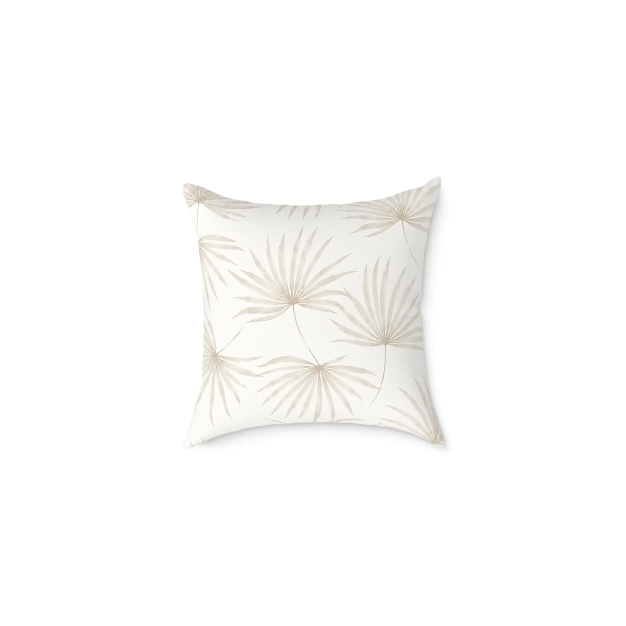 Neutral beige palm leaf pillow adding tropical texture to a coastal sofa