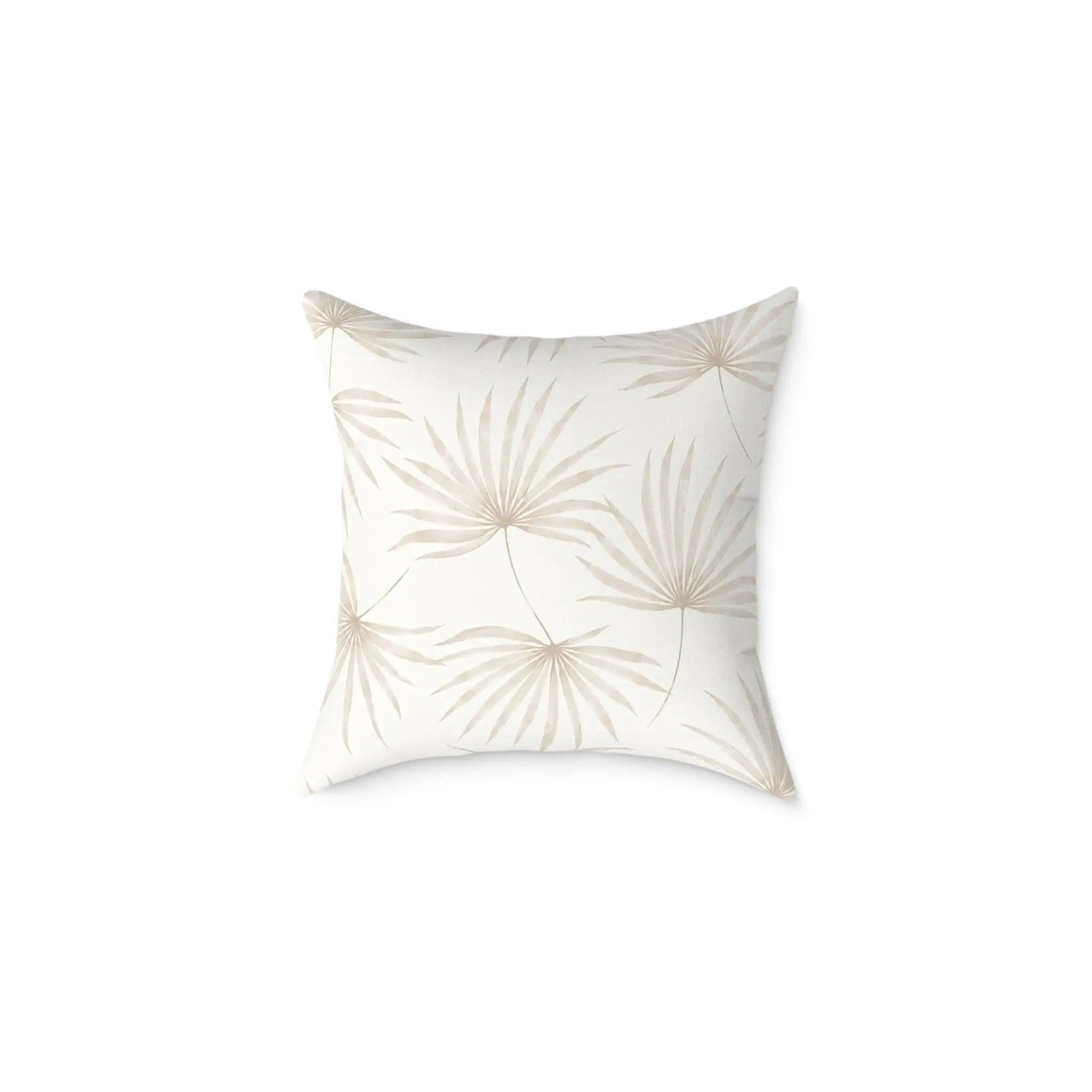 Beige palm leaf pillow styled with rattan and natural wood accents in a coastal space