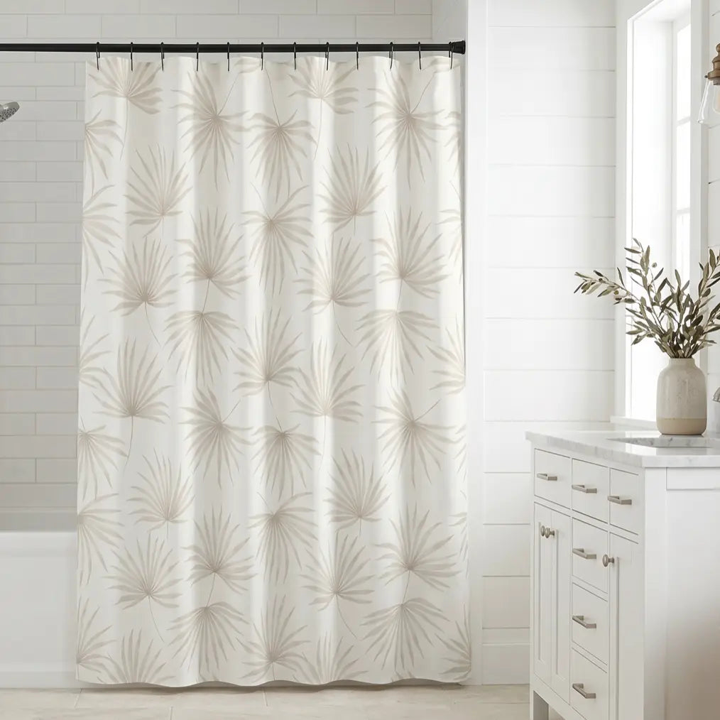 Beige palm leaf shower curtain in a bright coastal bathroom with neutral decor