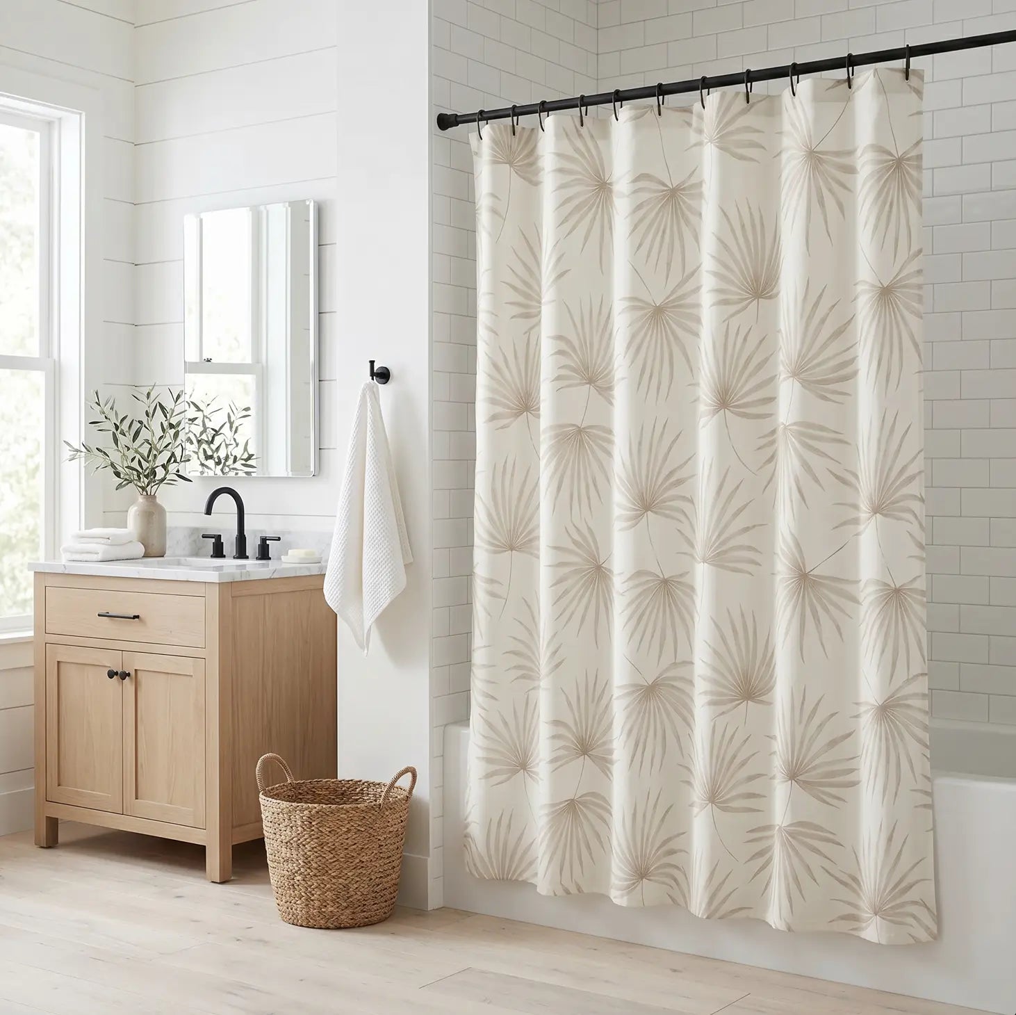 Neutral beige palm leaf shower curtain adding tropical texture to a coastal bathroom.