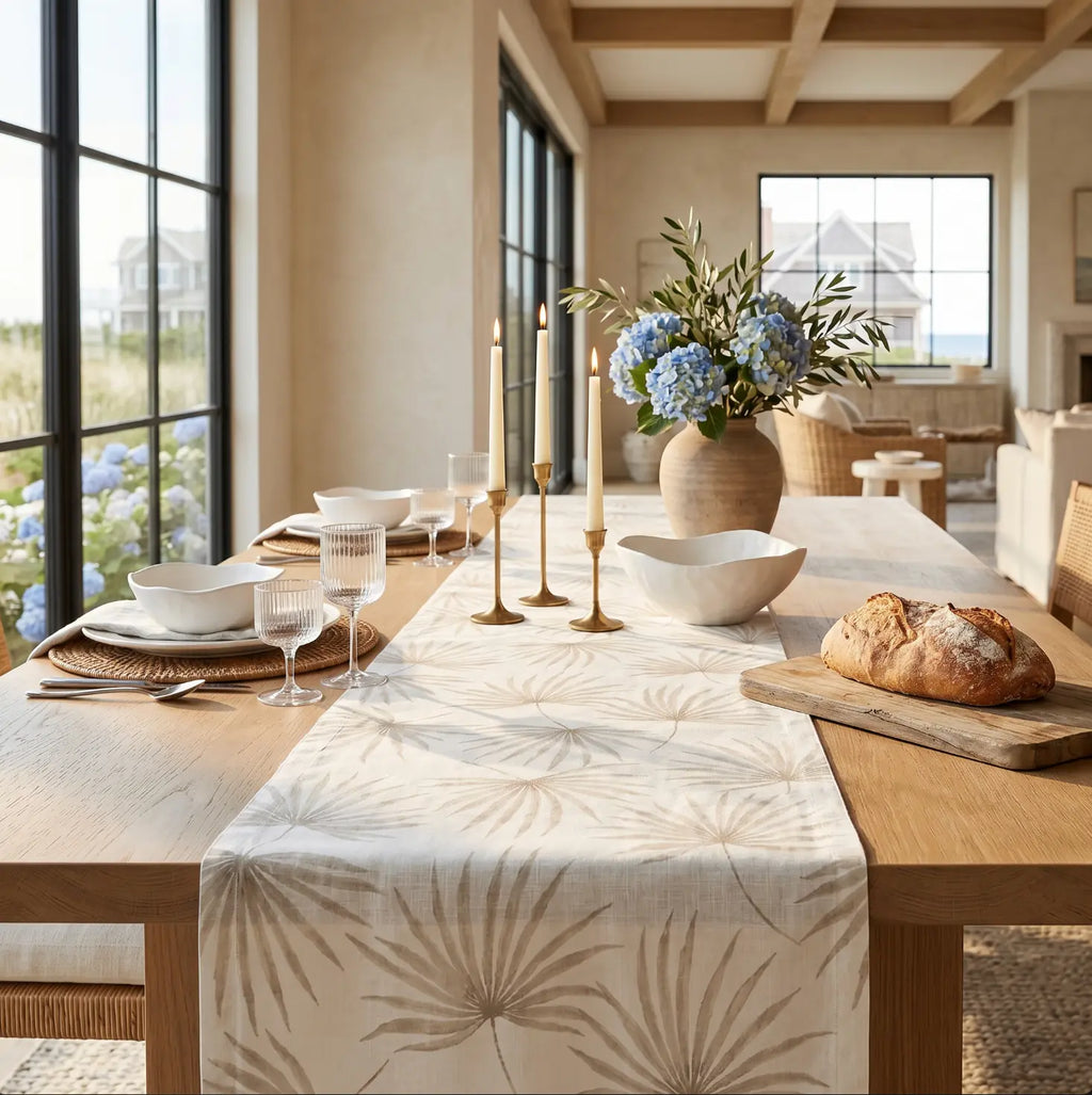 Neutral beige palm leaf table runner adding soft tropical texture to a coastal table