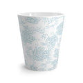 White ceramic cup with light blue floral pattern on a white background