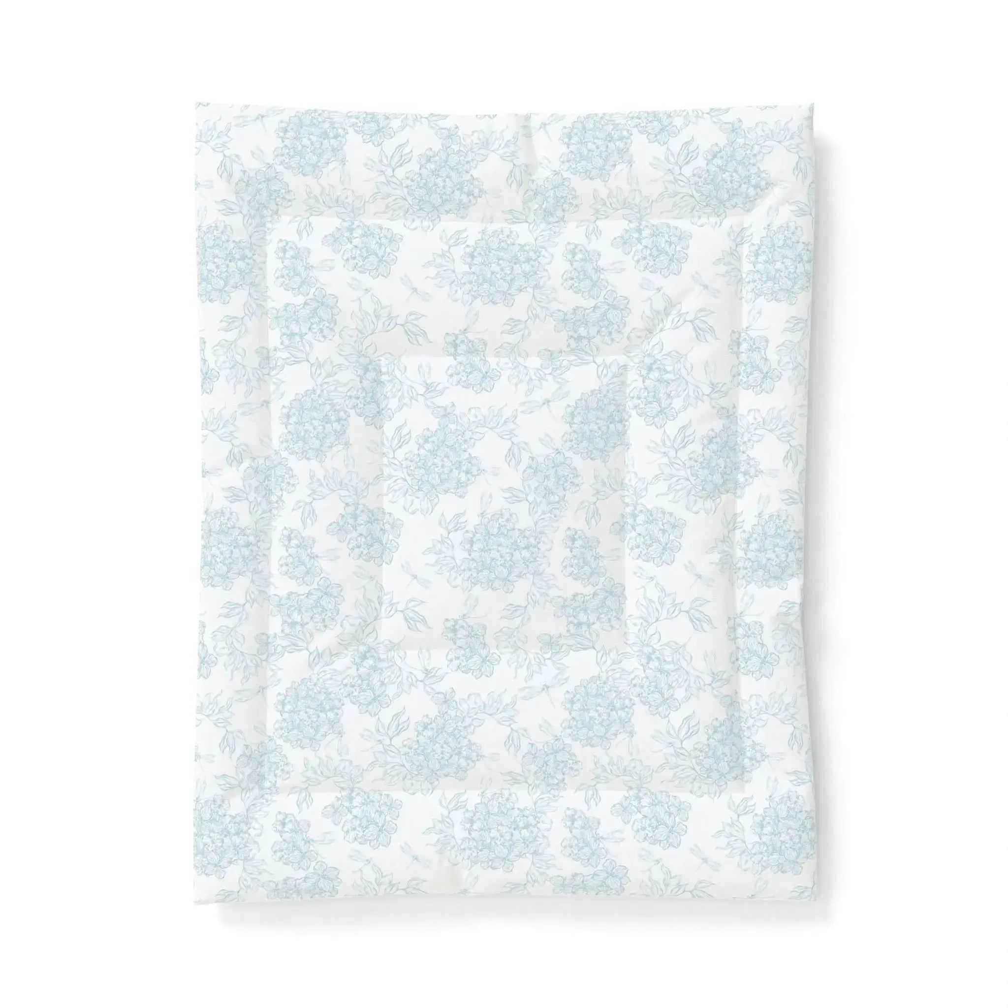 Blue and white floral comforter on a queen bed in a relaxed coastal farmhouse bedroom