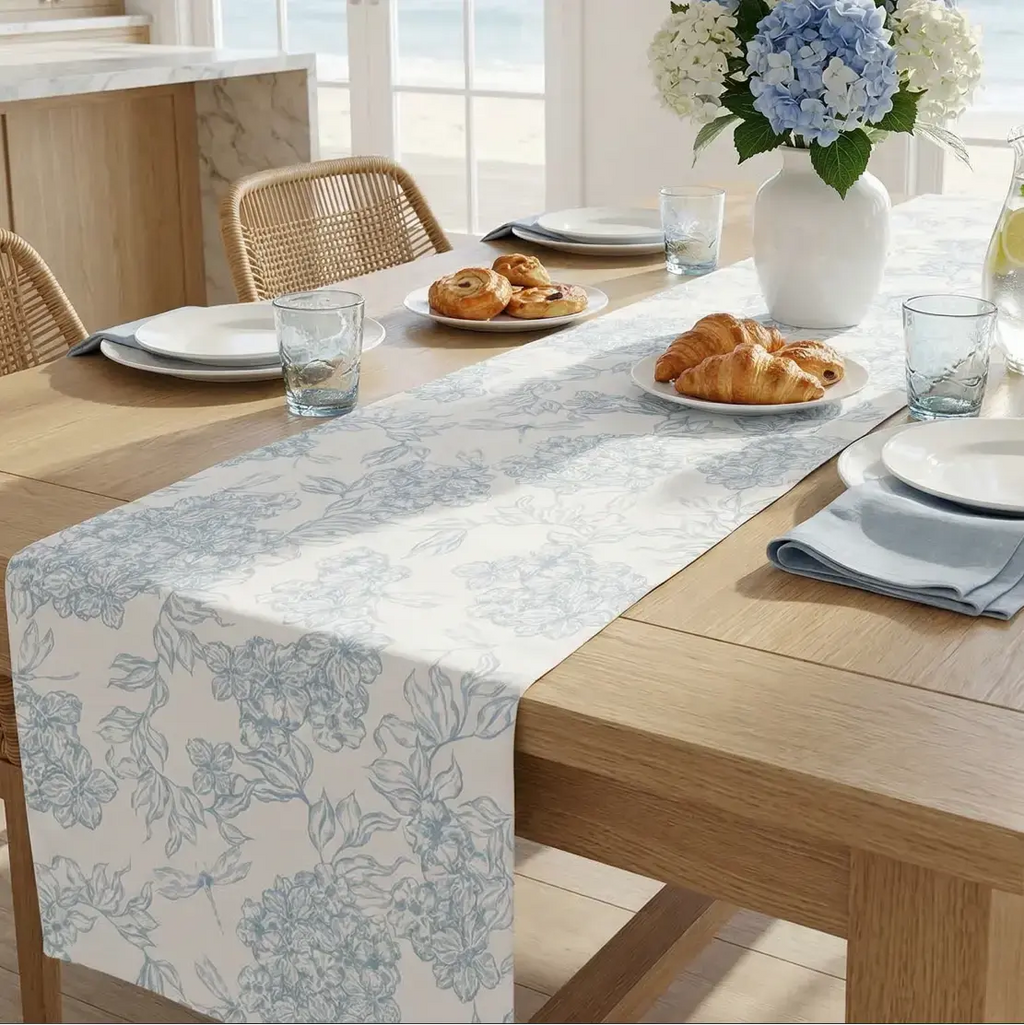 Rectangular blue and white floral table runner styled with white dishes