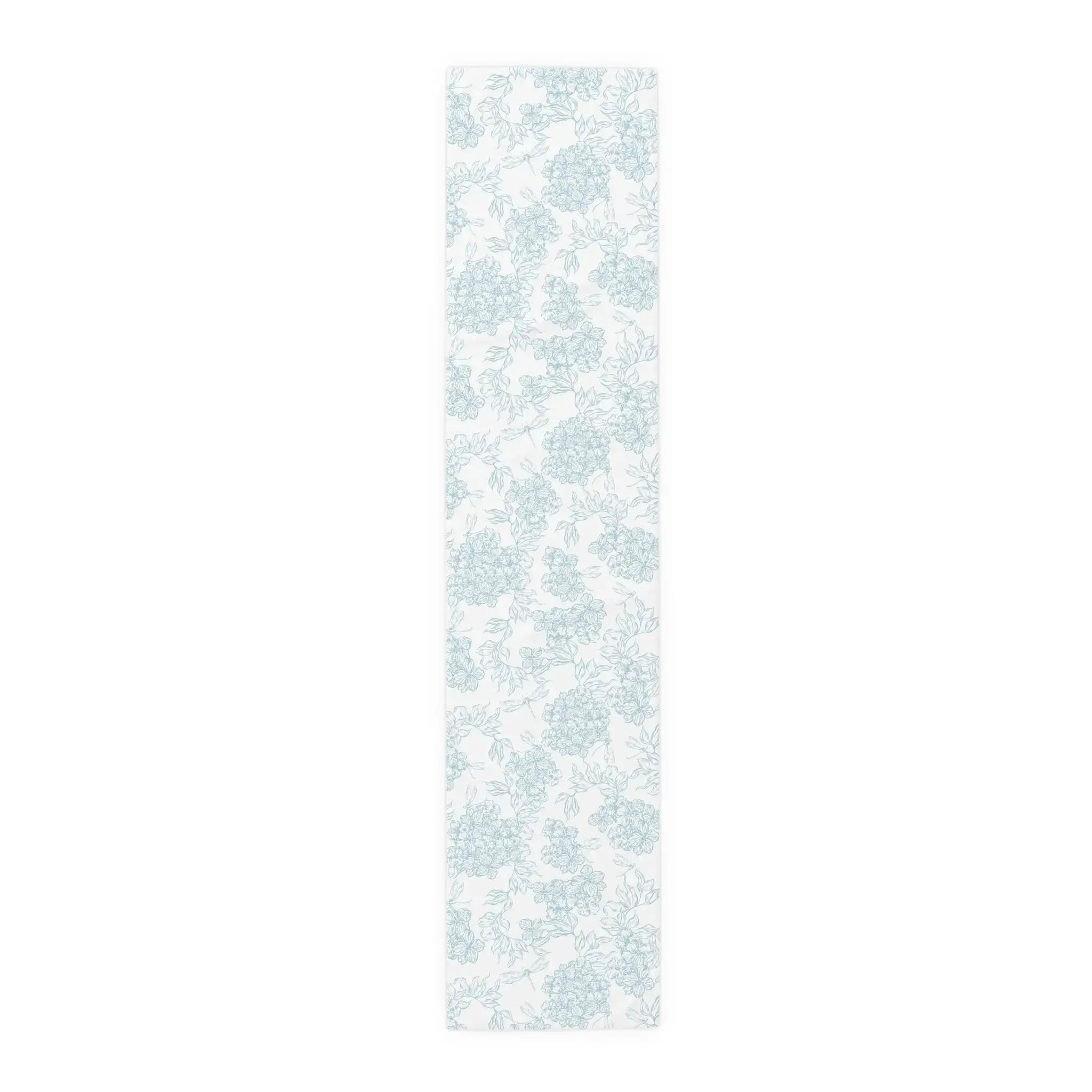 Folded blue and white floral table runner showing soft cotton fabric