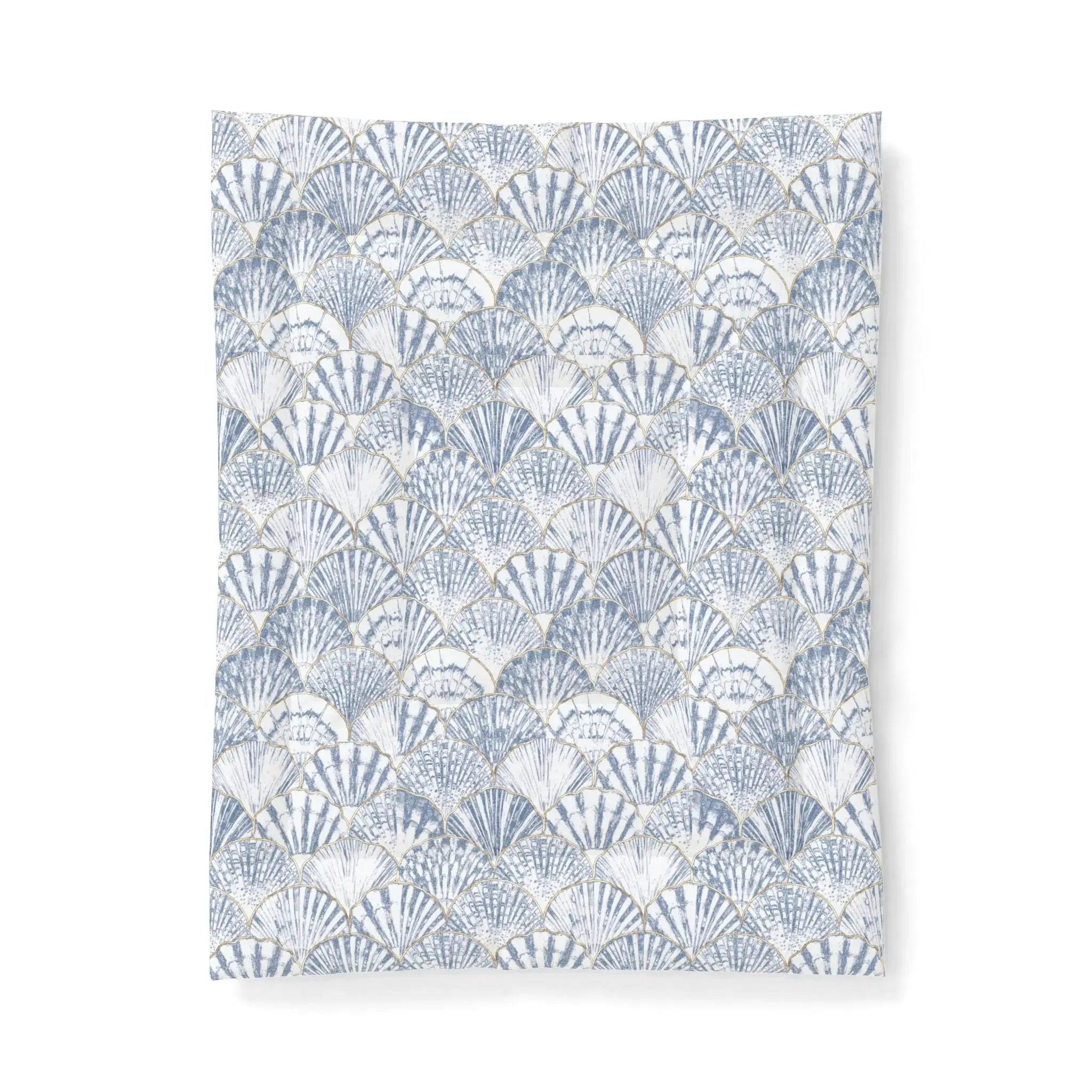 Blue and white seashell comforter creating nautical bedding for a seaside guest room