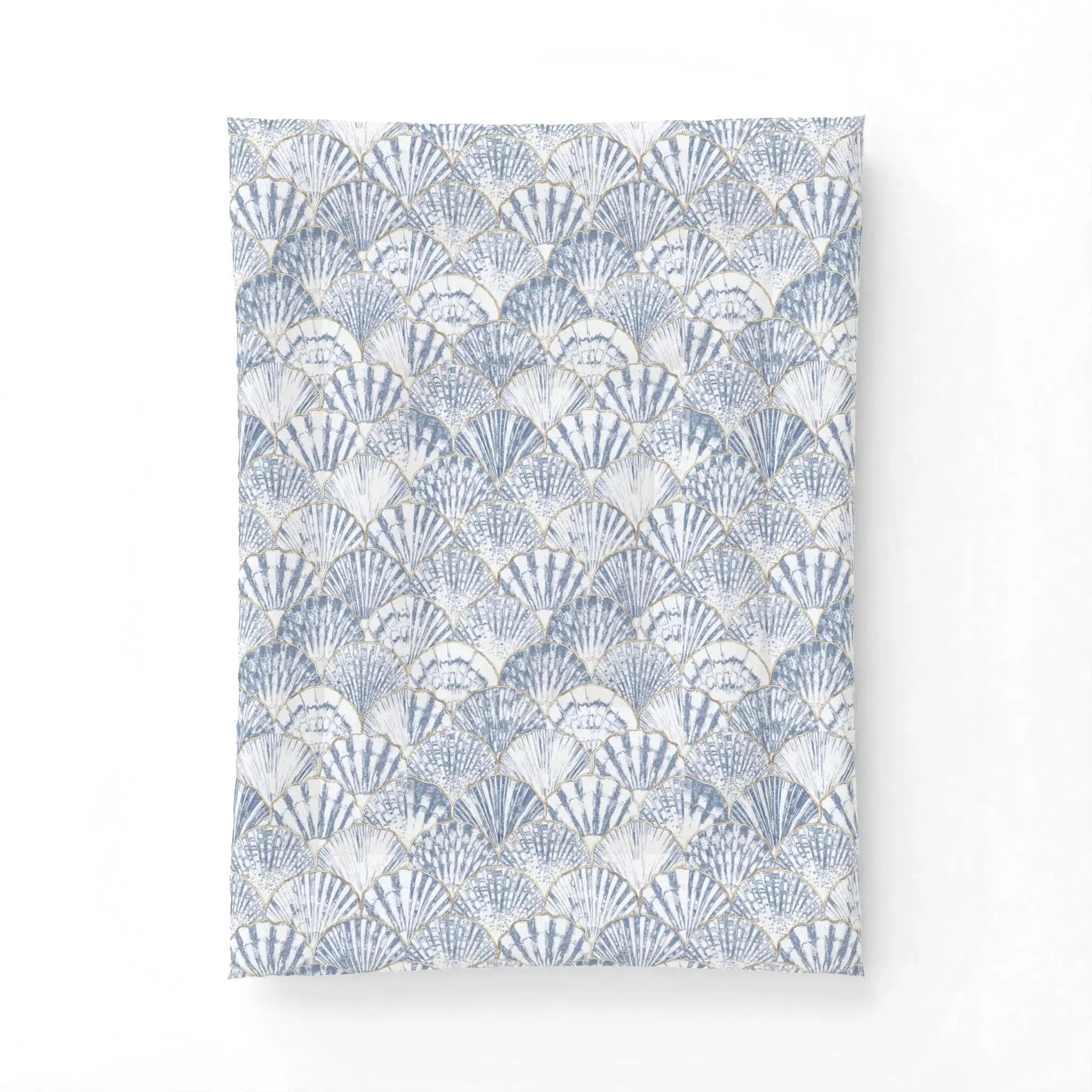 Closeup of blue and white seashell pattern on coastal comforter set.