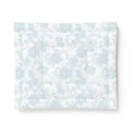 Blue and white seashell comforter creating nautical bedding in a seaside guest room