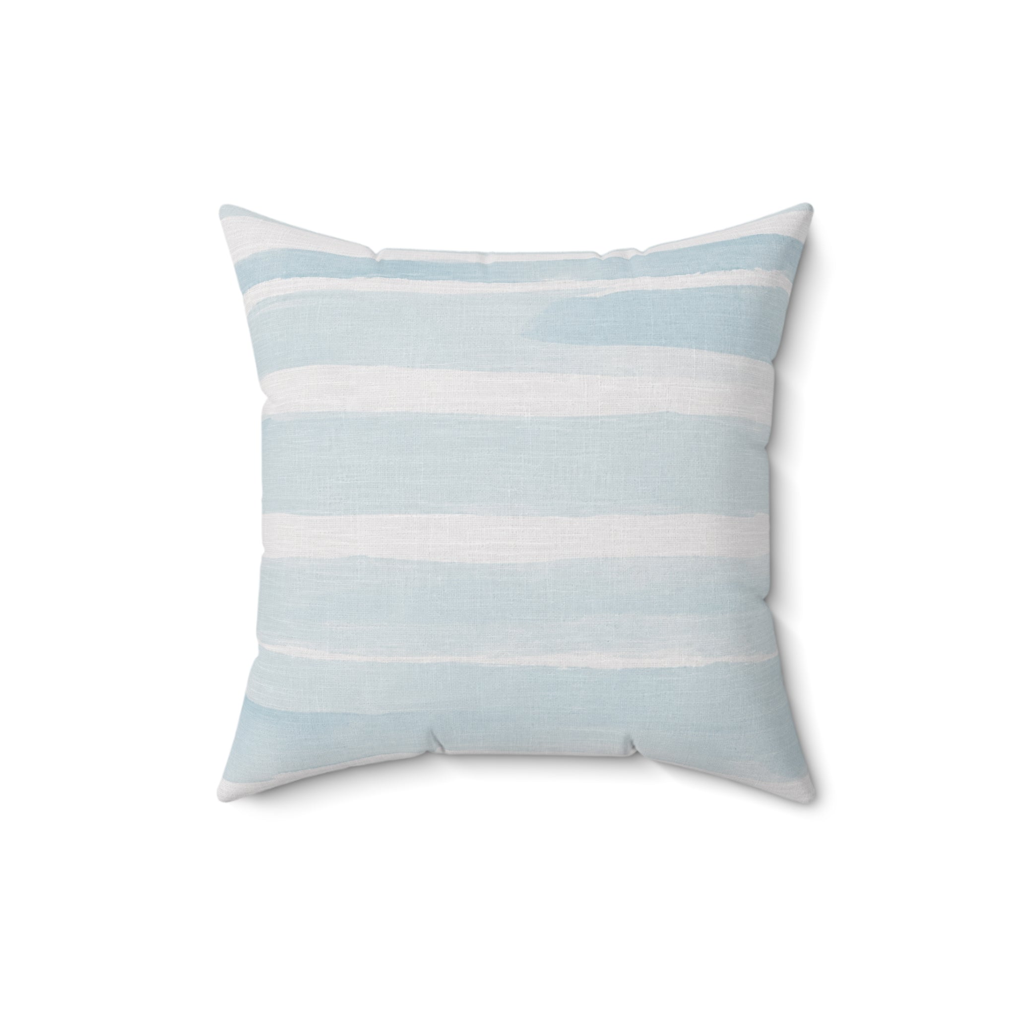 Nautical blue and white stripe accent pillow used as coastal décor on a couch