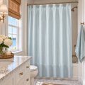 Blue and white striped shower curtain for coastal bathroom decor