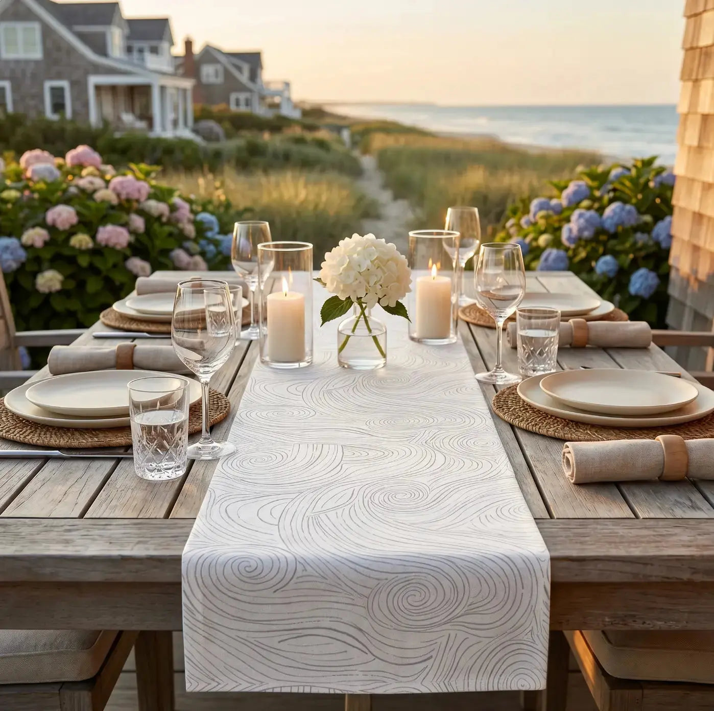 Blue and white swirl table runner on a coastal dining table with modern place settings