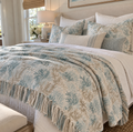 Blue and beige coastal woven blanket featuring a delicate botanical coral pattern.