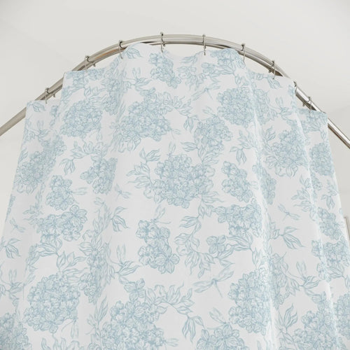 Sophisticated coastal bathroom featuring a blue botanical shower curtain