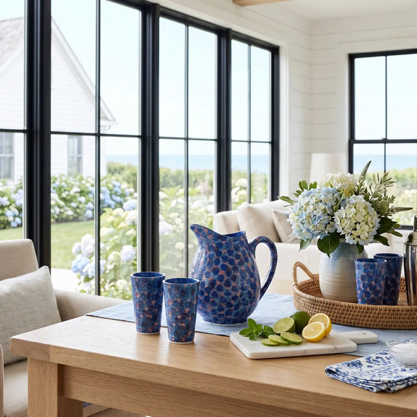 Blue coastal pitcher filled with water and lemon slices on a table
