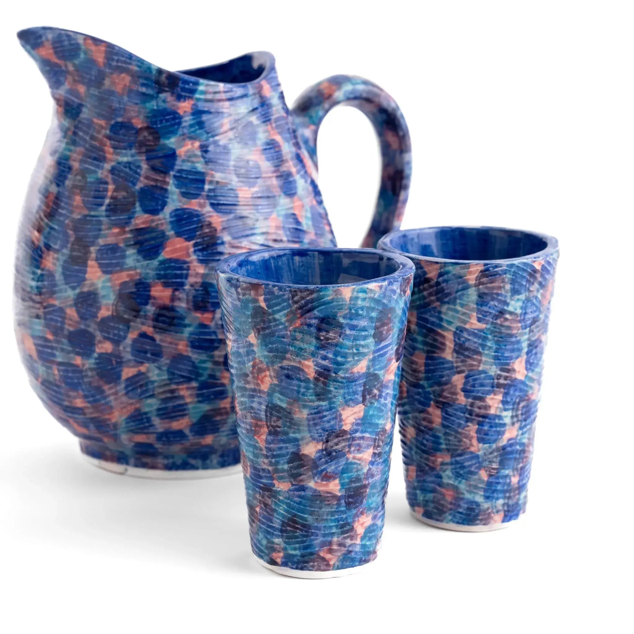 Coastal blue ceramic pitcher on an open shelf in a kitchen.