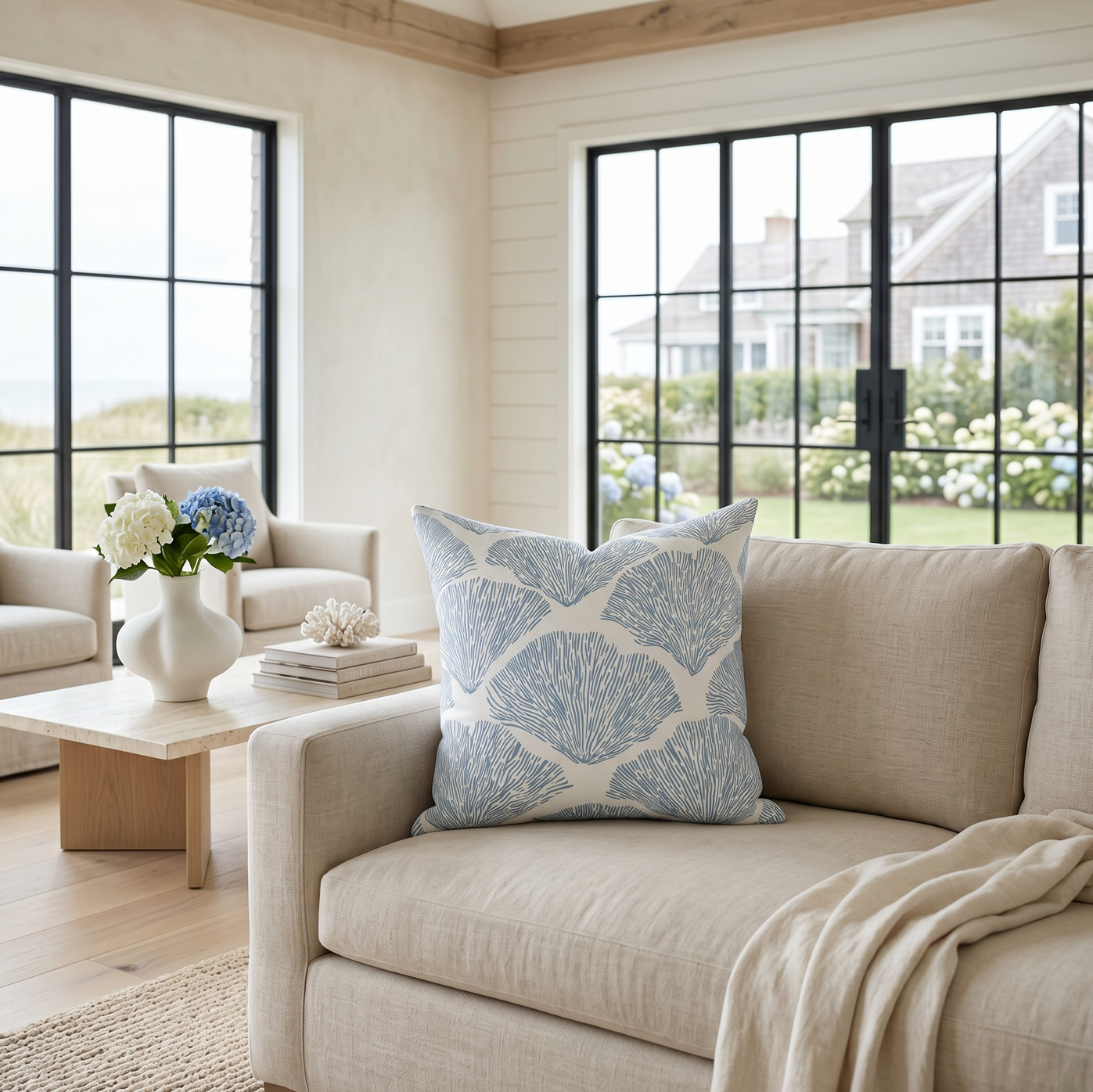 Blue coral pattern throw pillow adding a coastal accent to a beach house style room